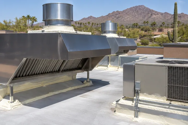 Restaurant roof with exhaust hoods and units sealed with spray foam