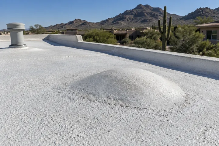 Raised blister in the coating of a foam roof