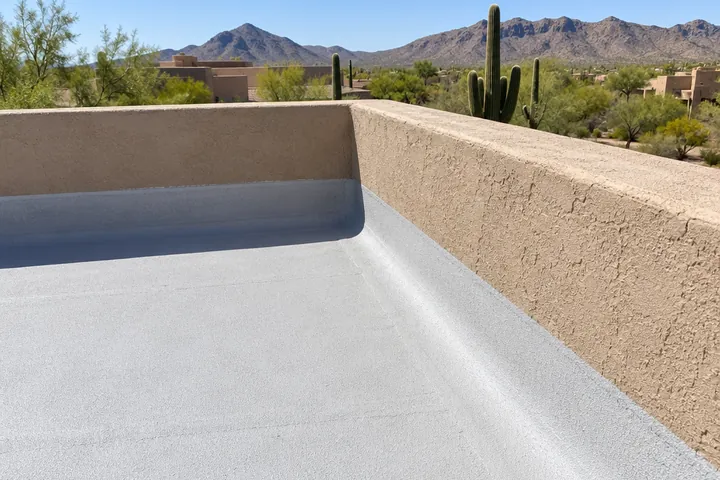 Flat foam roof running up the inside of a stucco parapet wall on a Scottsdale home
